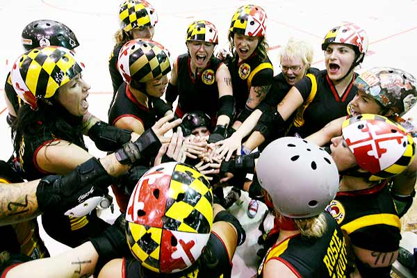 The Charm City All Stars huddle before their bout against the Philly Liberty Belles