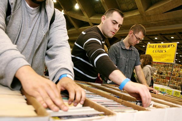 Shoppers look for comic books at the Cards, Comics, and Collectibles booth at Baltimore Comic-Con